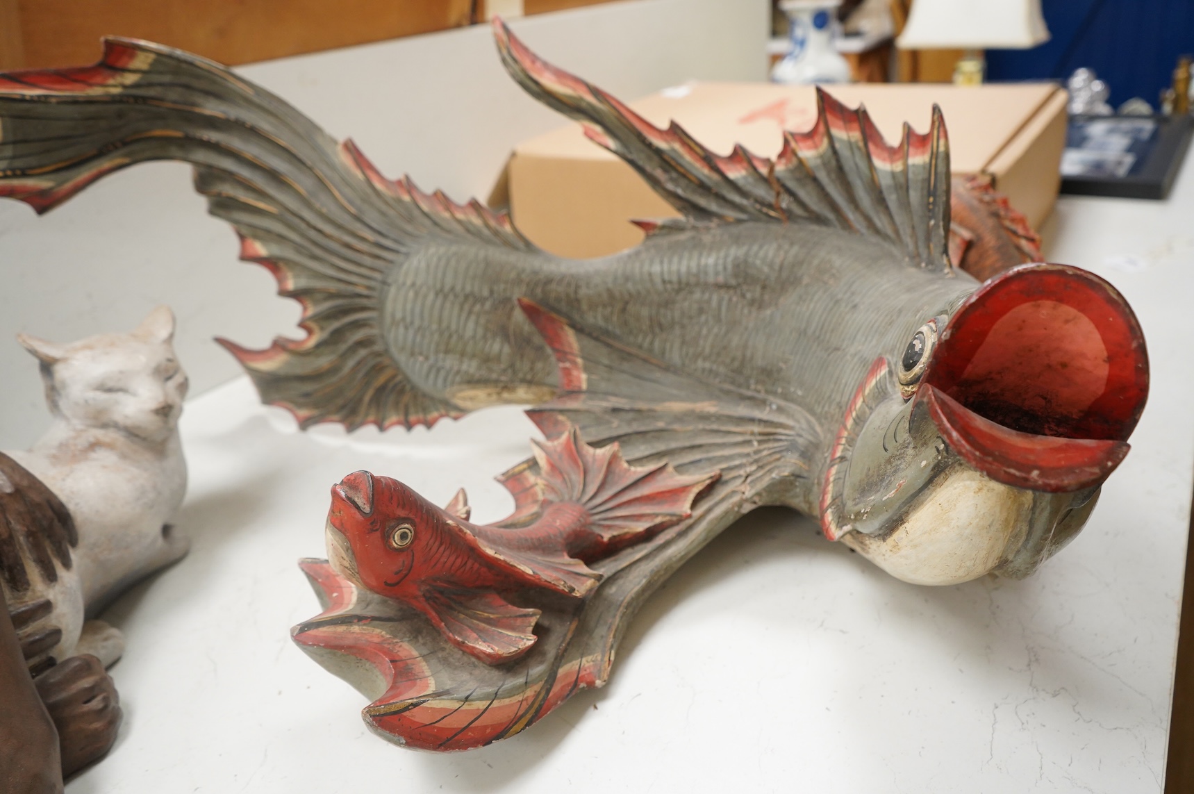 A large carved and painted wood hanging fish